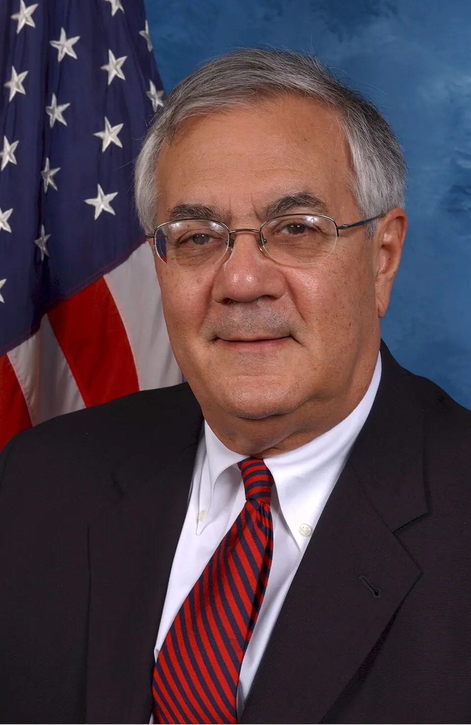 Official-style portrait of Barney Frank in a dark suit and tie, seated, from a U.S. House photograph in the public domain.