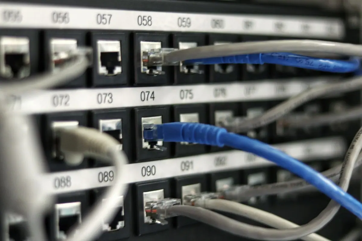 Server room corridor with network hardware, representing Cisco enterprise infrastructure and data-center demand.