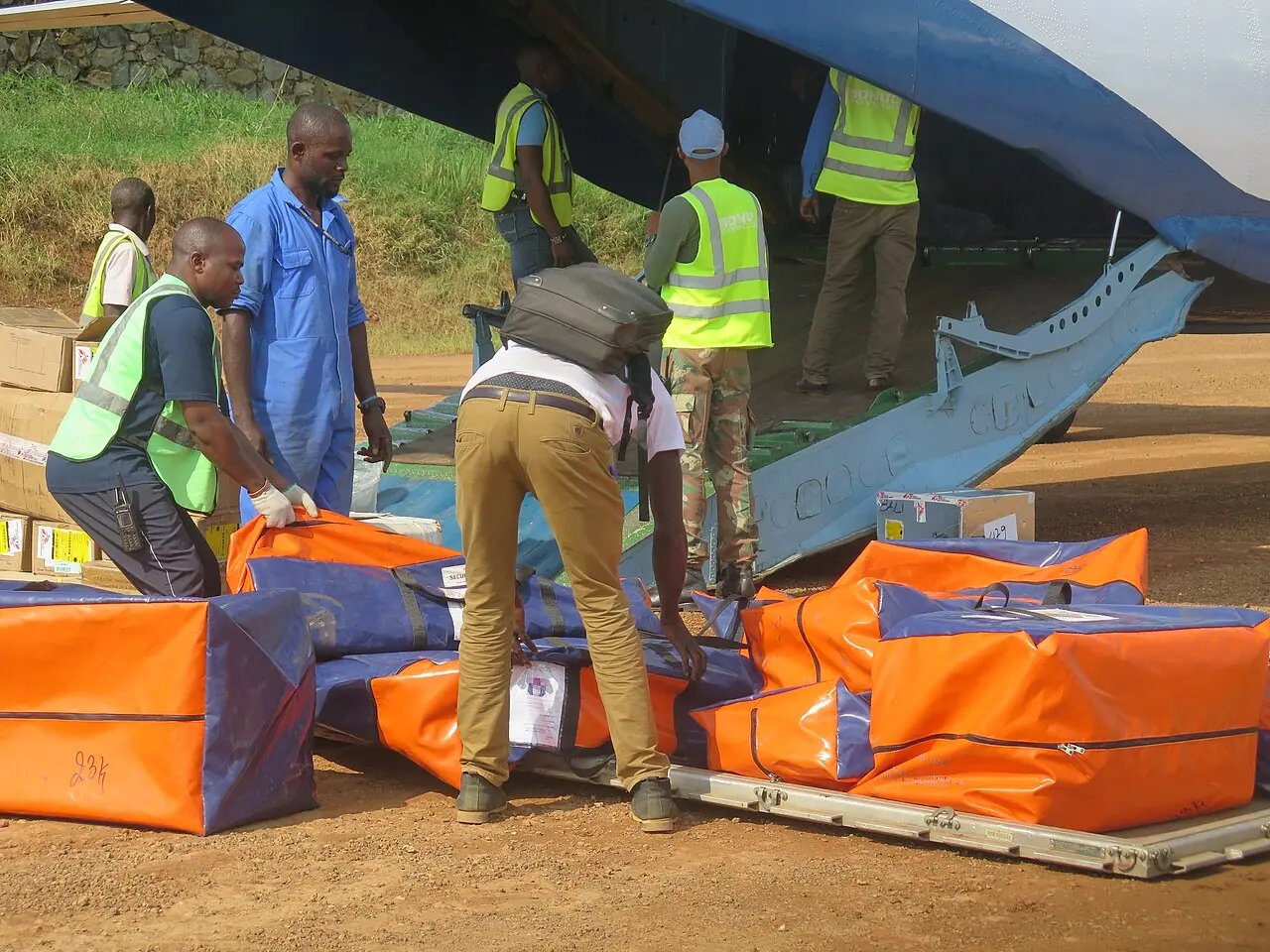 UN peacekeepers and workers unload medical supplies from a truck in Beni, North Kivu, DRC, during the 2018 Ebola response (Wikimedia Commons / MONUSCO photo, CC BY-SA 2.0)—illustrates humanitarian logistics in a past DRC Ebola wave; not a 2026 Ituri field photo or a specific US evacuation scene.