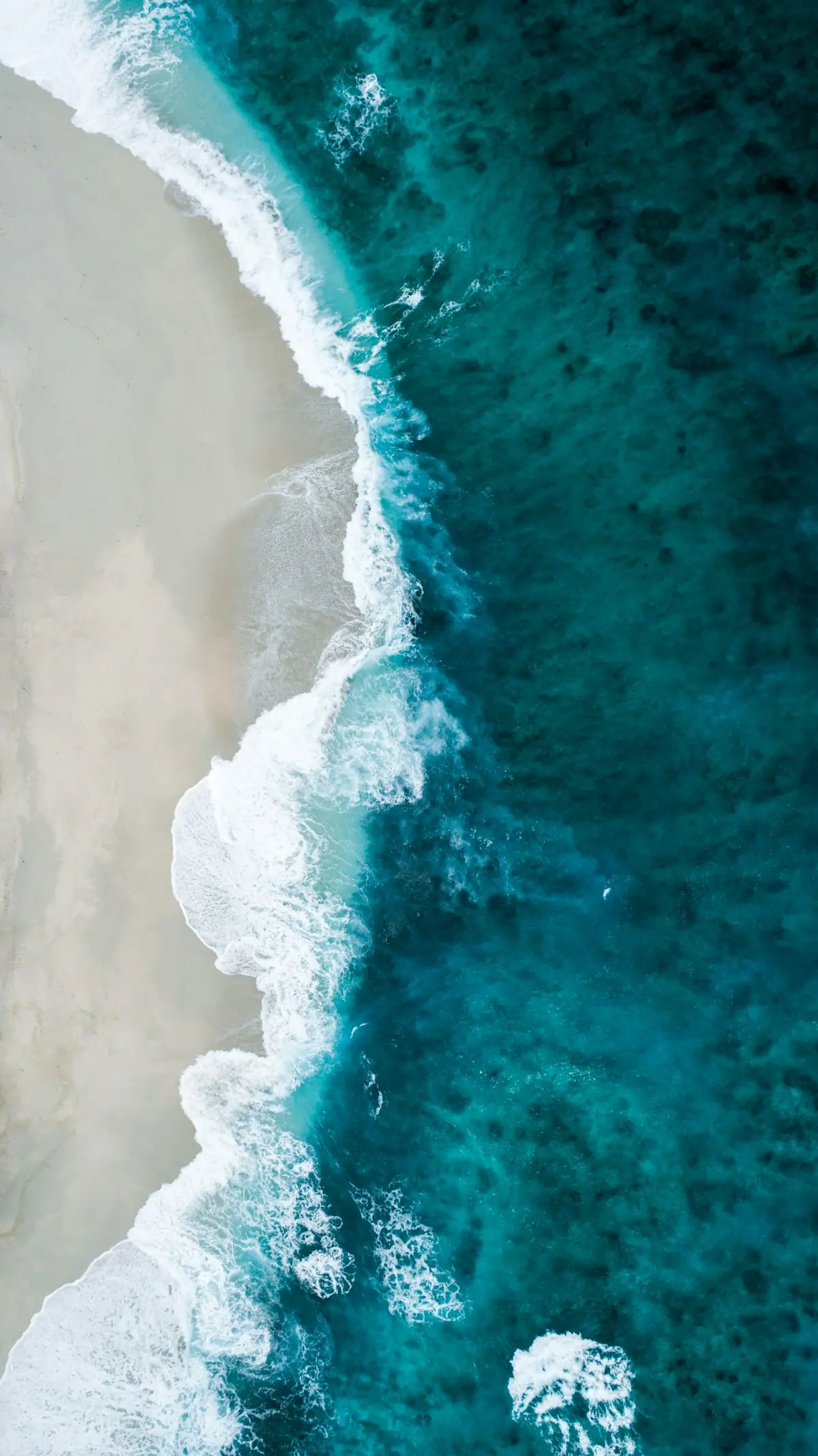 Open ocean under heavy cloud bands, evoking equatorial Pacific convection patterns tied to El Niño shifts.