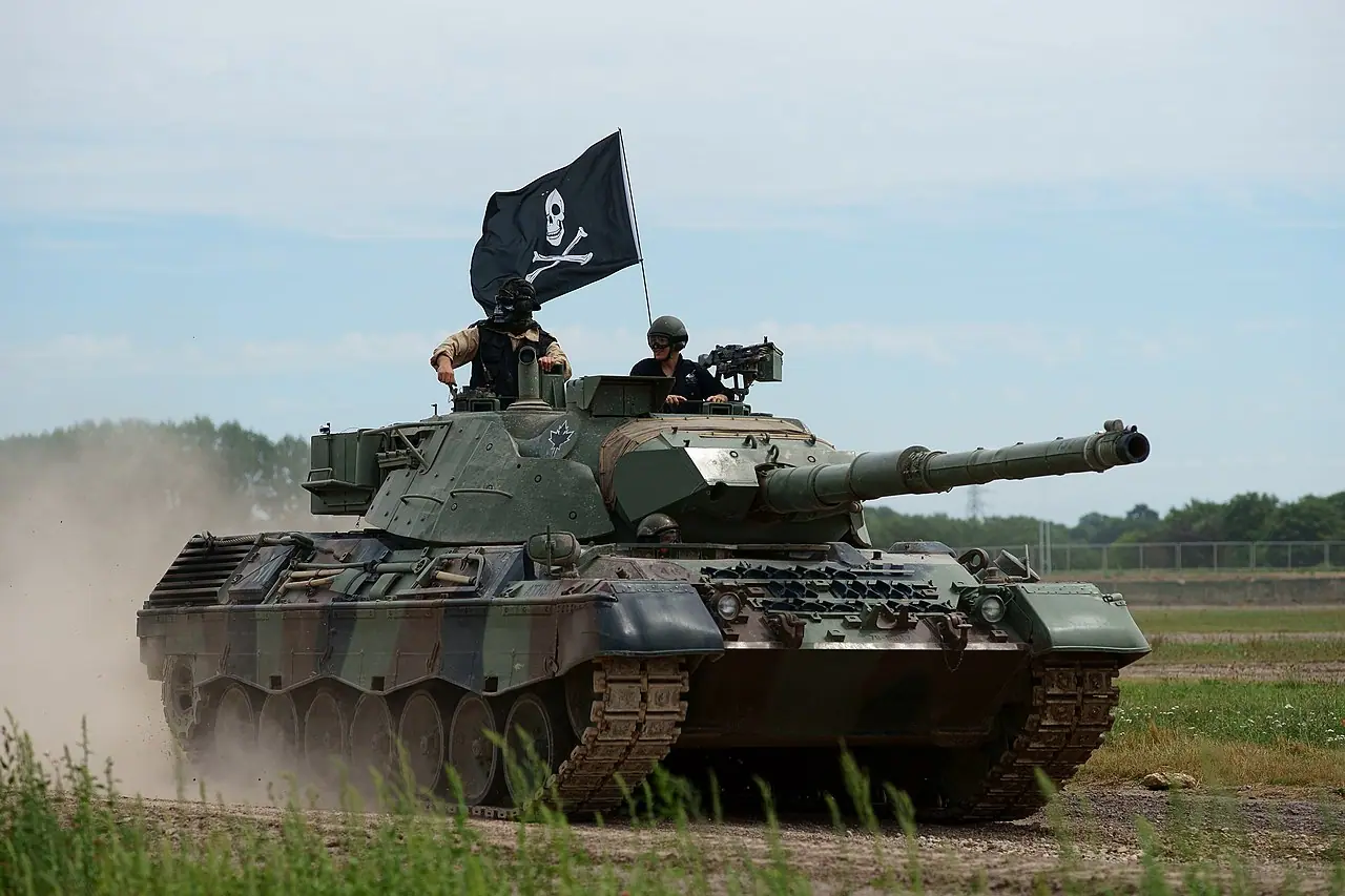 A Leopard tank in a field, representing the military heavy equipment rotation to Poland.
