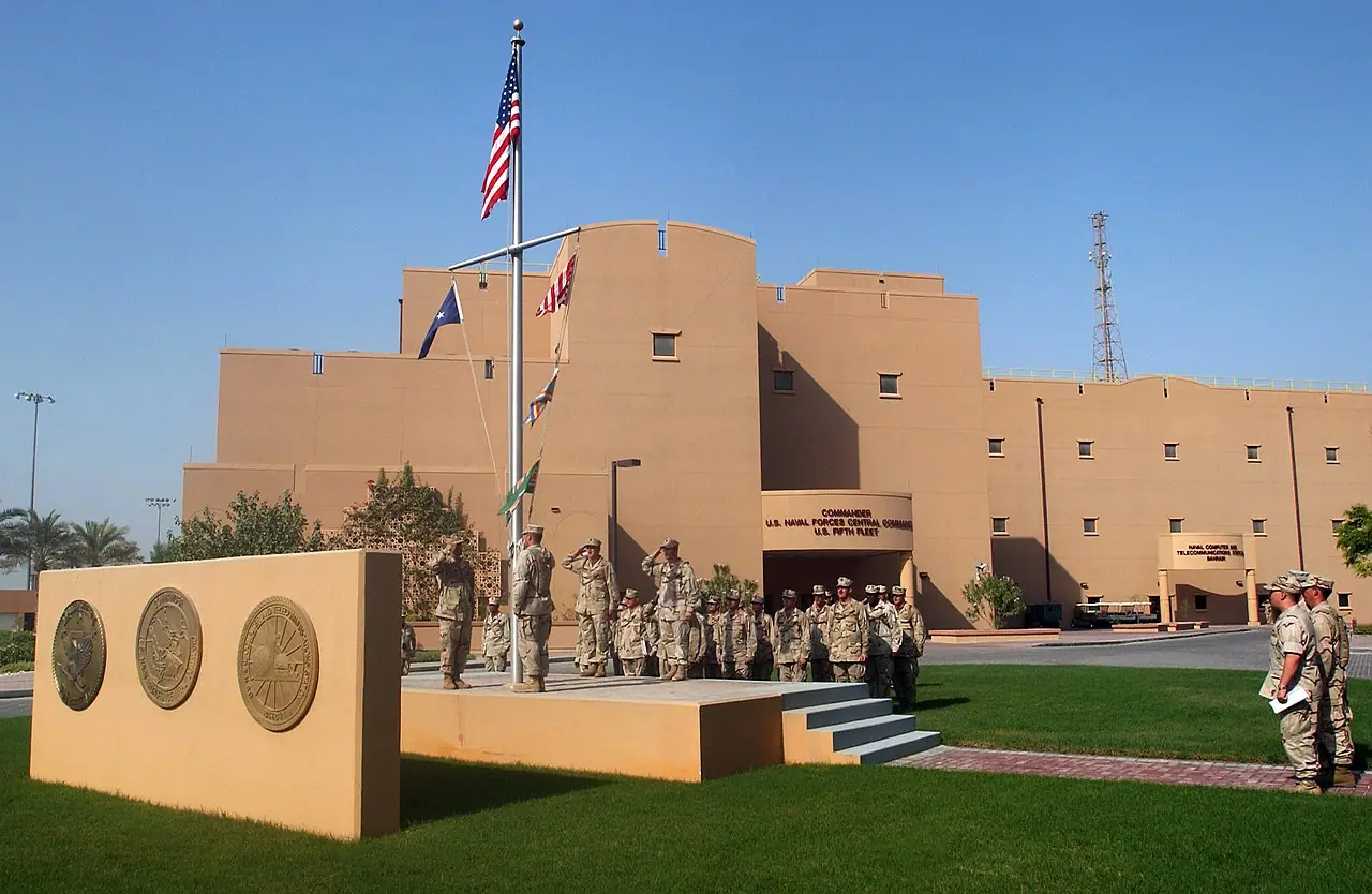 2005 U.S. Navy file photo of morning colors at Naval Support Activity Bahrain—Wikimedia Commons archival image of a facility the Post reporting highlights among heavily damaged sites; it is not a satellite frame, battle damage close-up, or current operational status photo from the 2026 conflict.