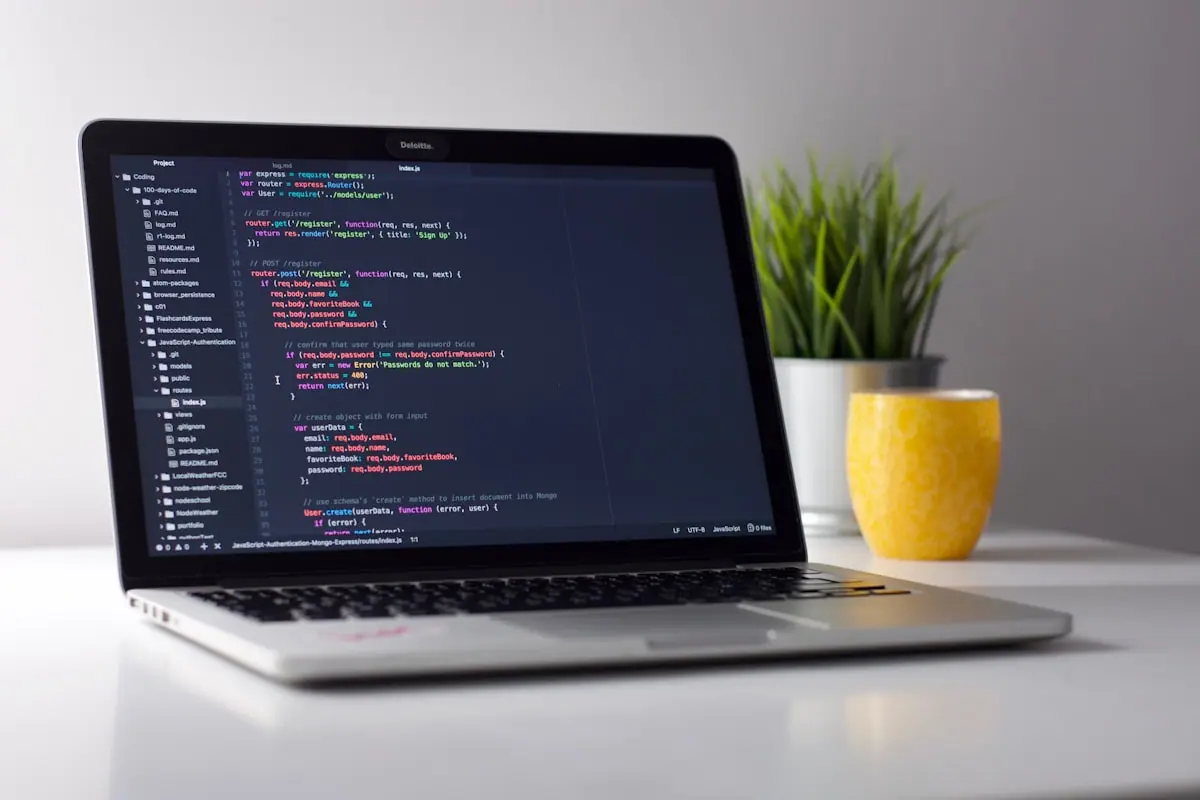 Laptop on a desk suggesting software-industry work—not any single company’s office or logo.