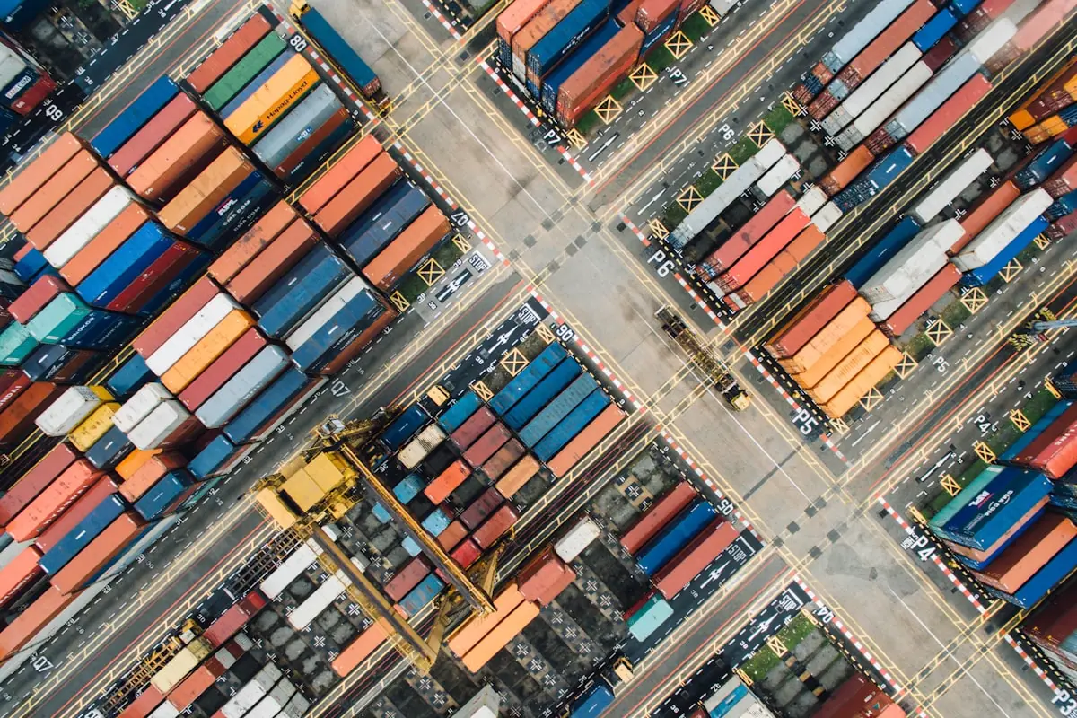 A large cargo ship loaded with containers, representing the international trade flow at the center of the US-China summit.